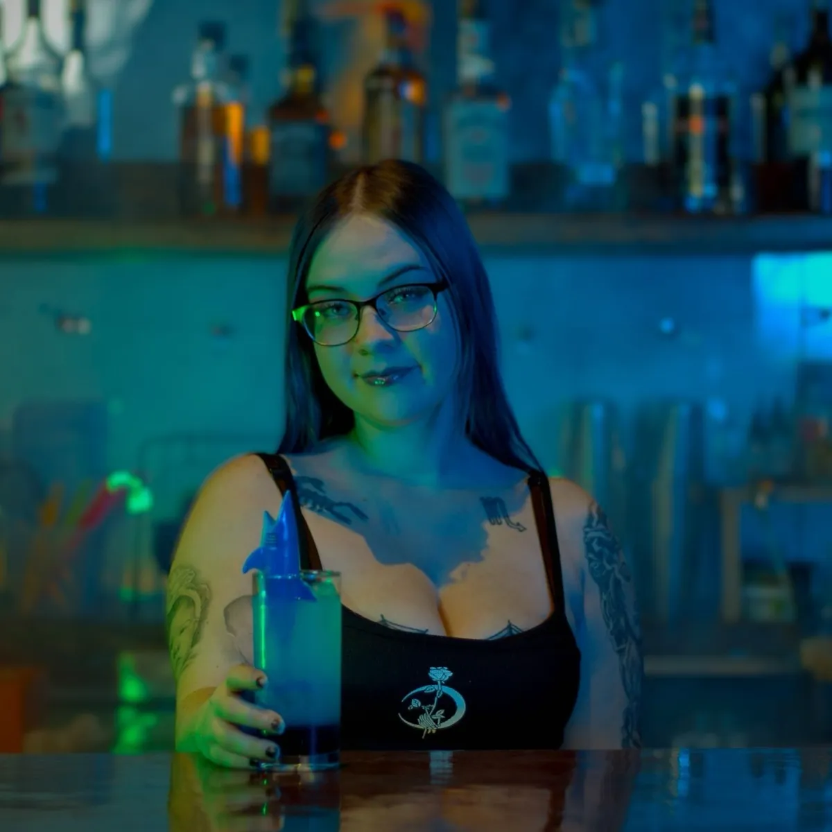 Bartender with blue drink