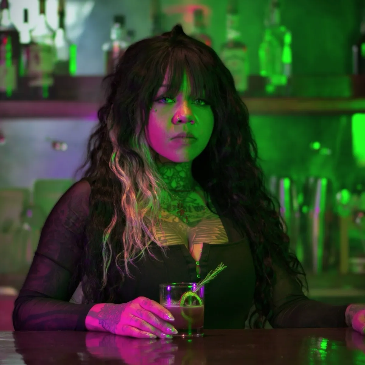 Bartender with cocktail in green light