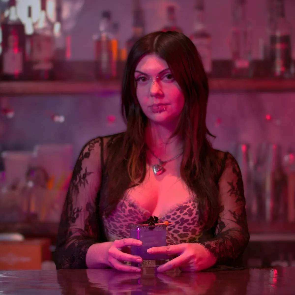 Bartender with purple cocktail